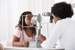 Optometrist conducting sight test on child